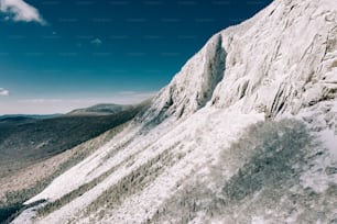 a person on a snowboard going down a snowy mountain