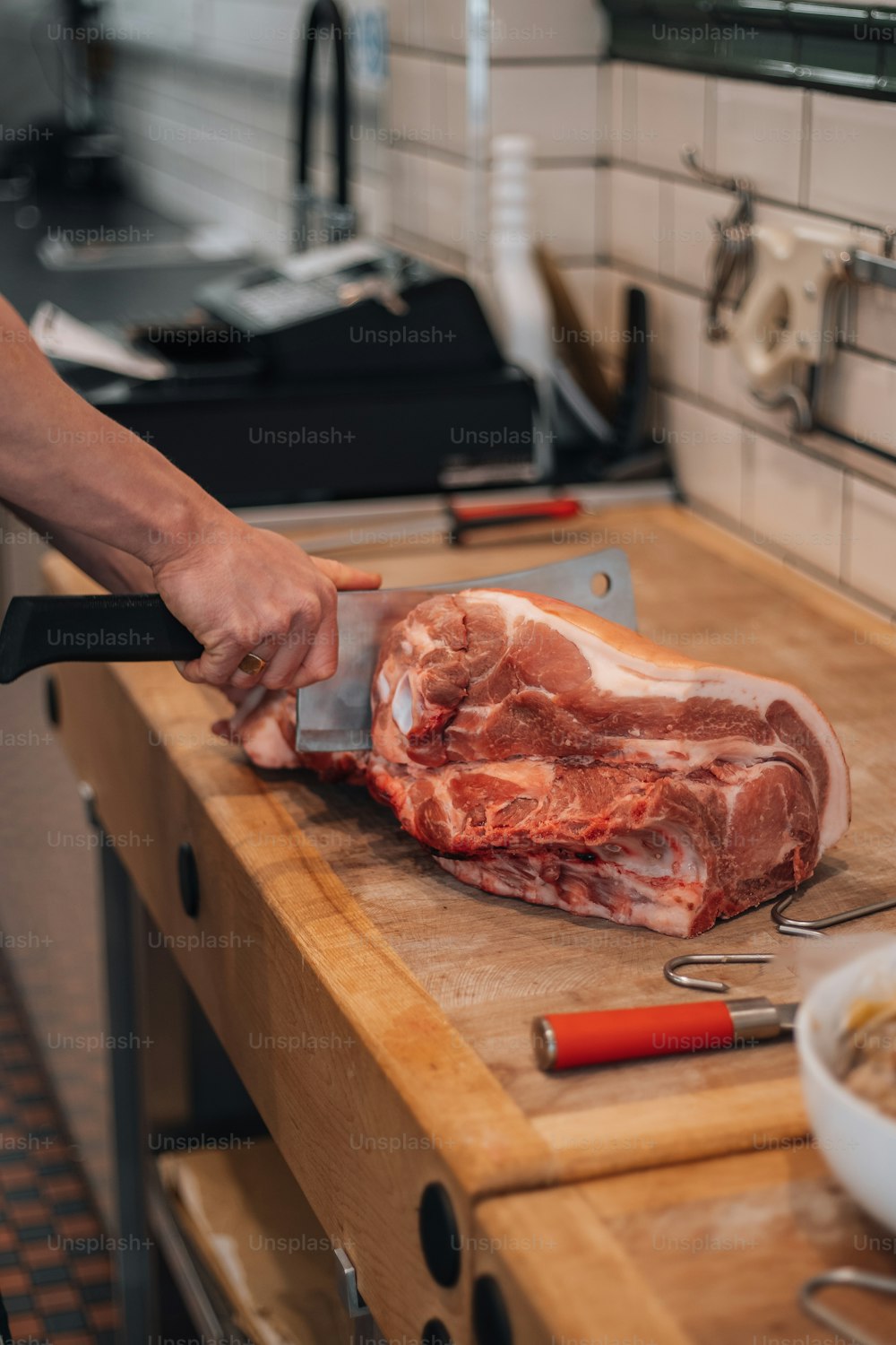 a person cutting meat