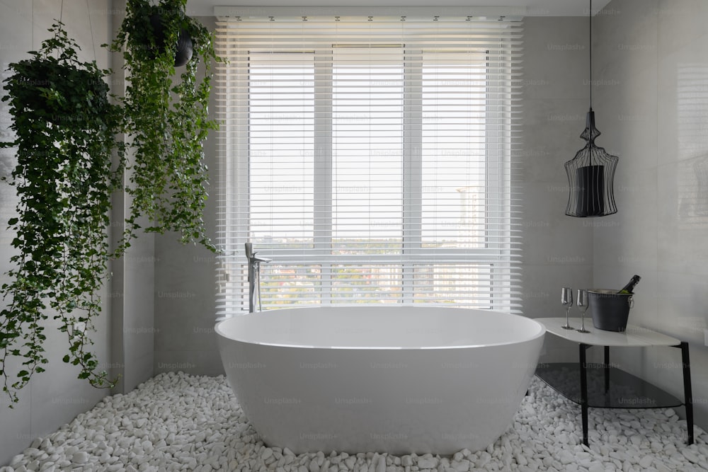 a bathtub and a table in a room with a window