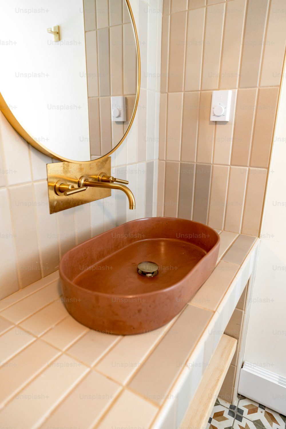 a bathroom with a round mirror