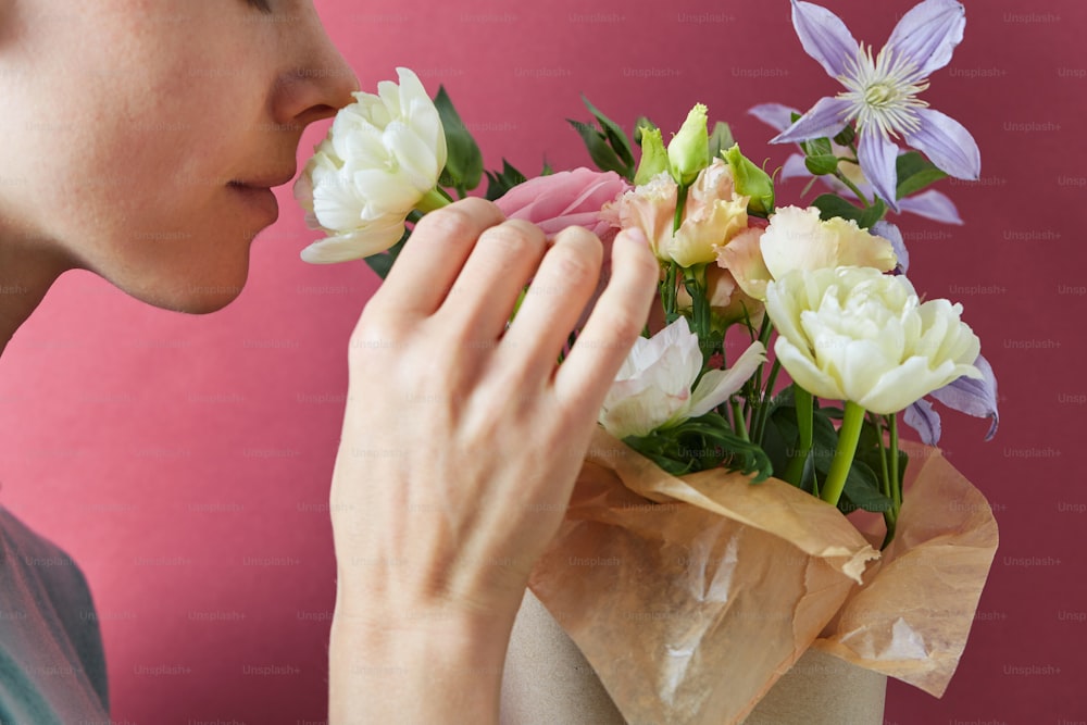 a woman holding a bouquet of flowers