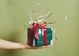 a hand holding a gift box