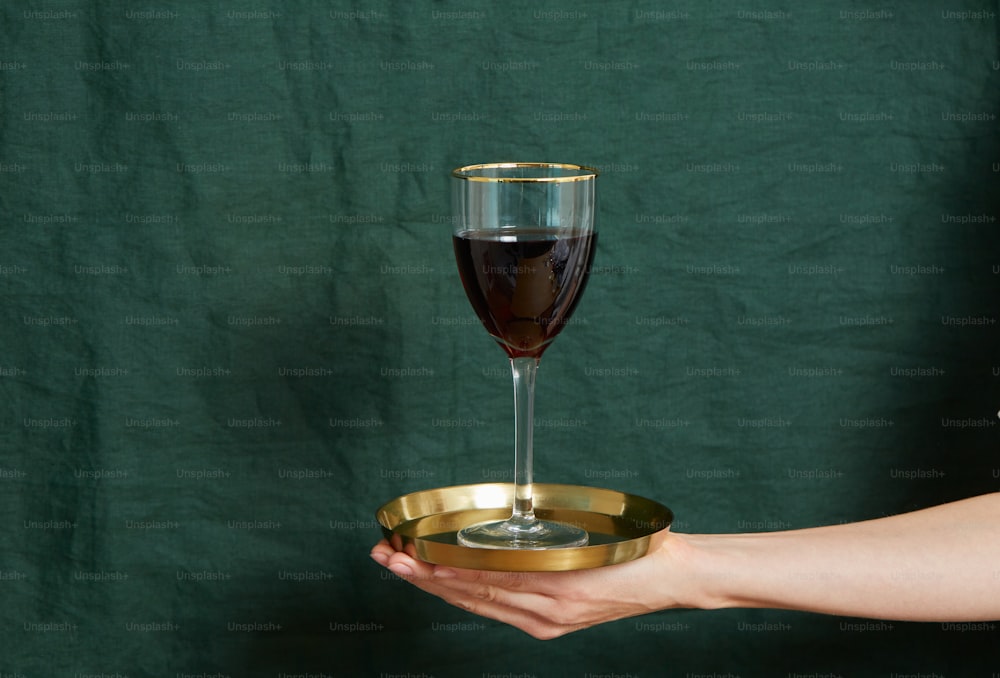 a hand holding a glass of wine