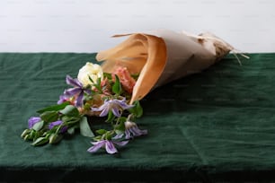 a person lying on a bed with flowers