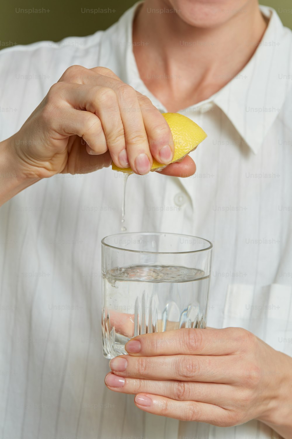 a person pouring liquid into a glass