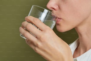 a person drinking from a glass