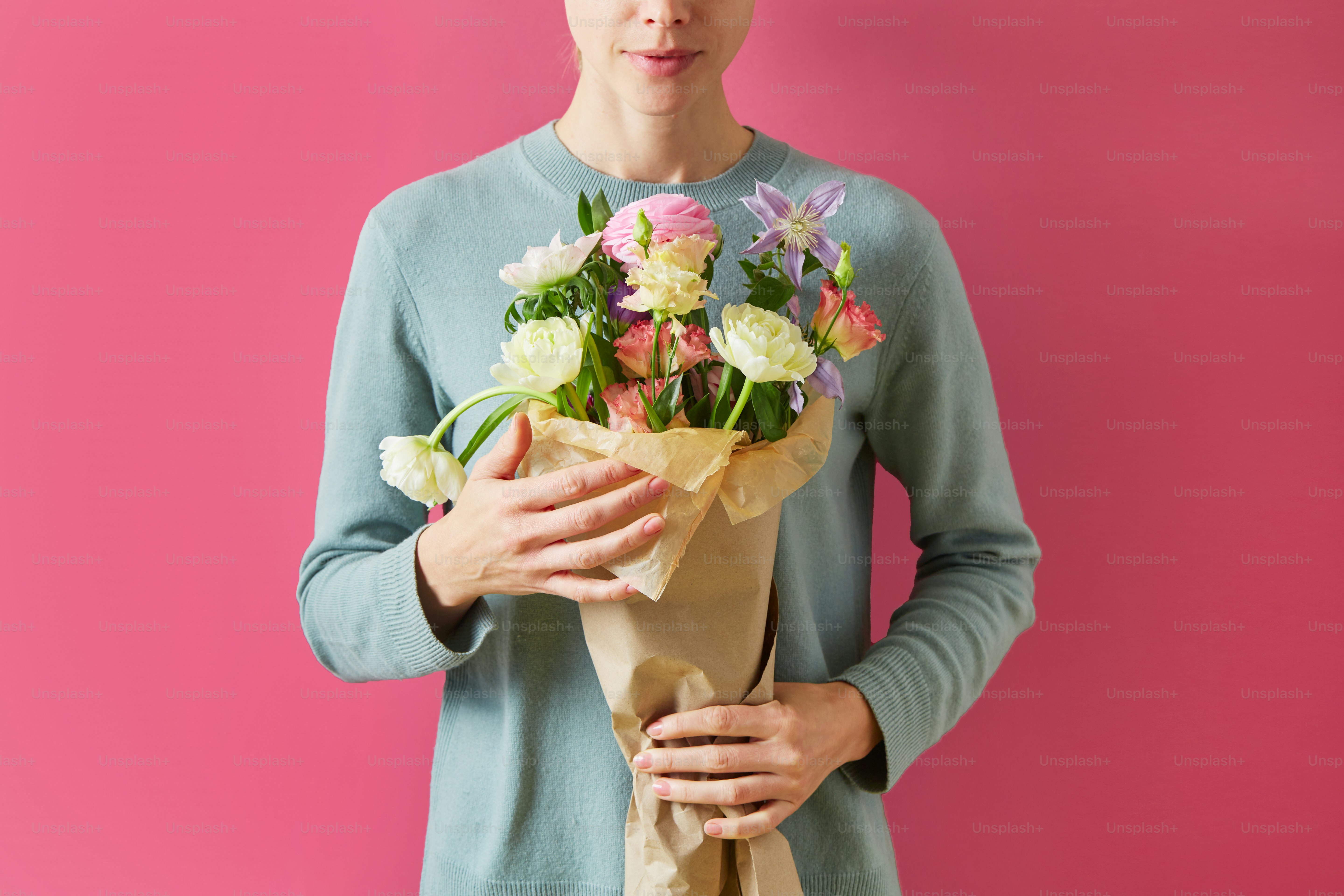 a woman holding a bouquet of flowers