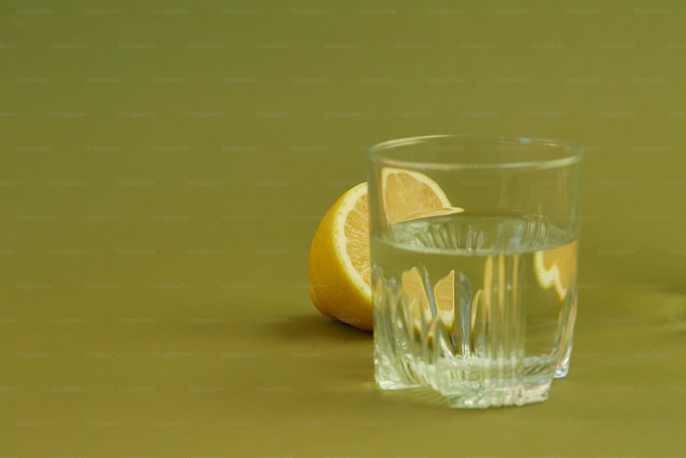 a glass of water and an orange