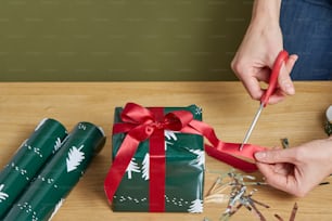 a person cutting a gift