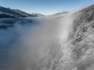 a large waterfall with snow on the sides