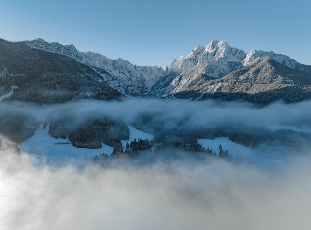 a mountain range with clouds below