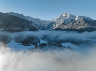 a mountain range with clouds below