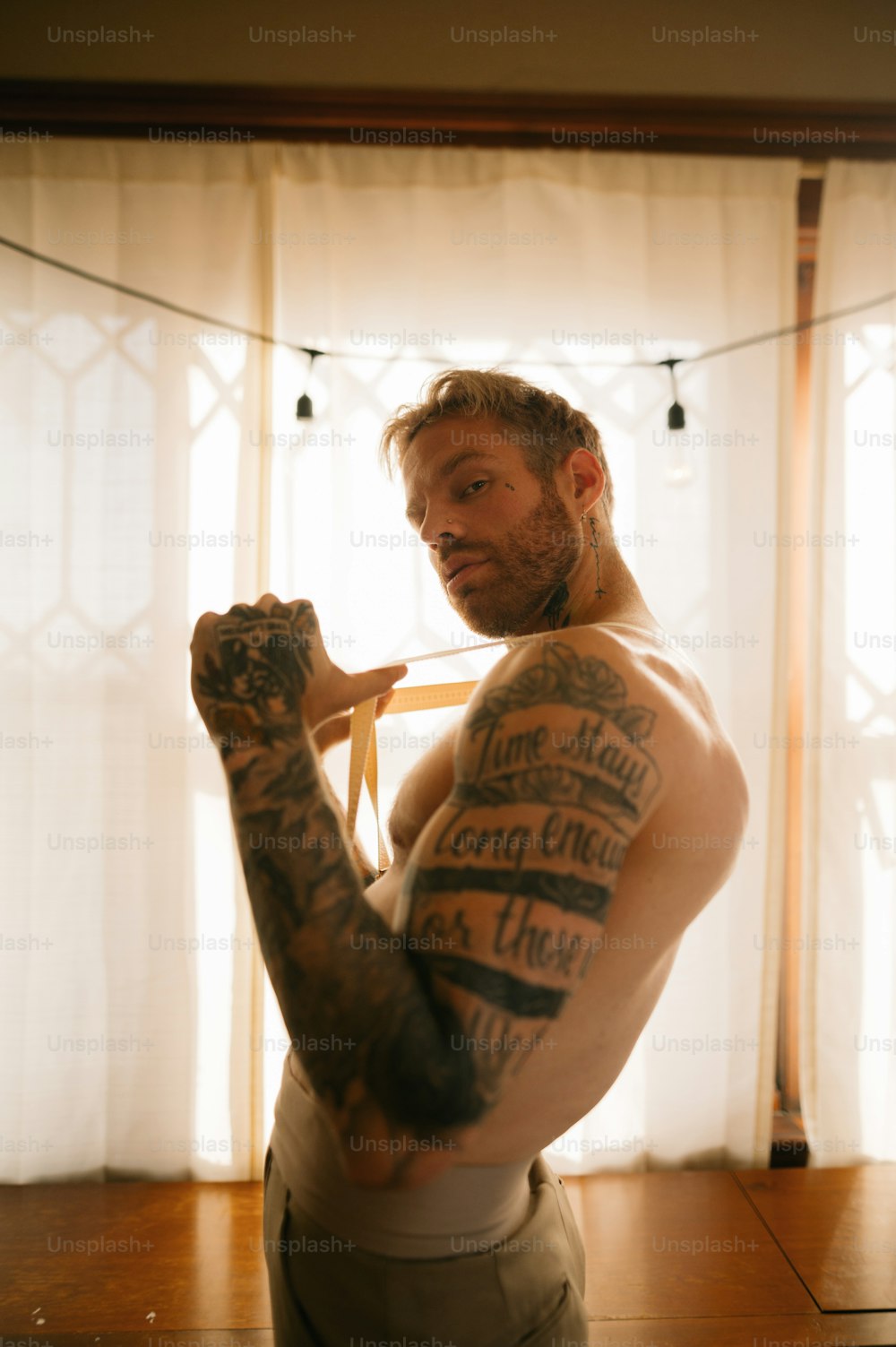 a man with tattoos flexing his arm