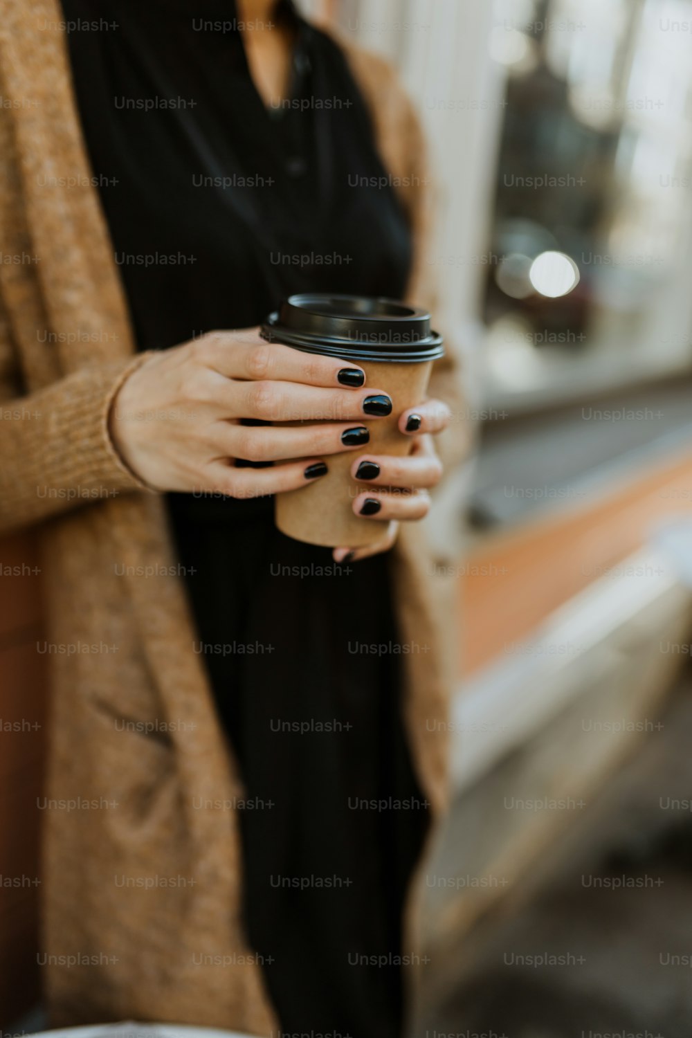 a person holding a coffee cup