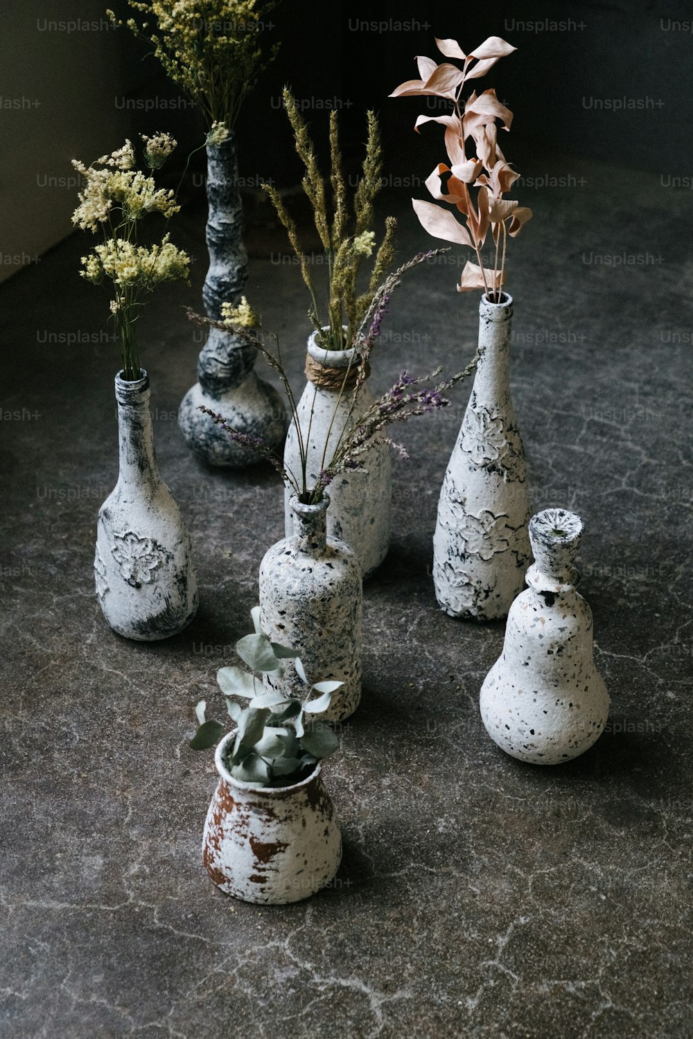 several vases with flowers