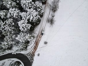 Una vista aérea de un coche conduciendo en una carretera nevada