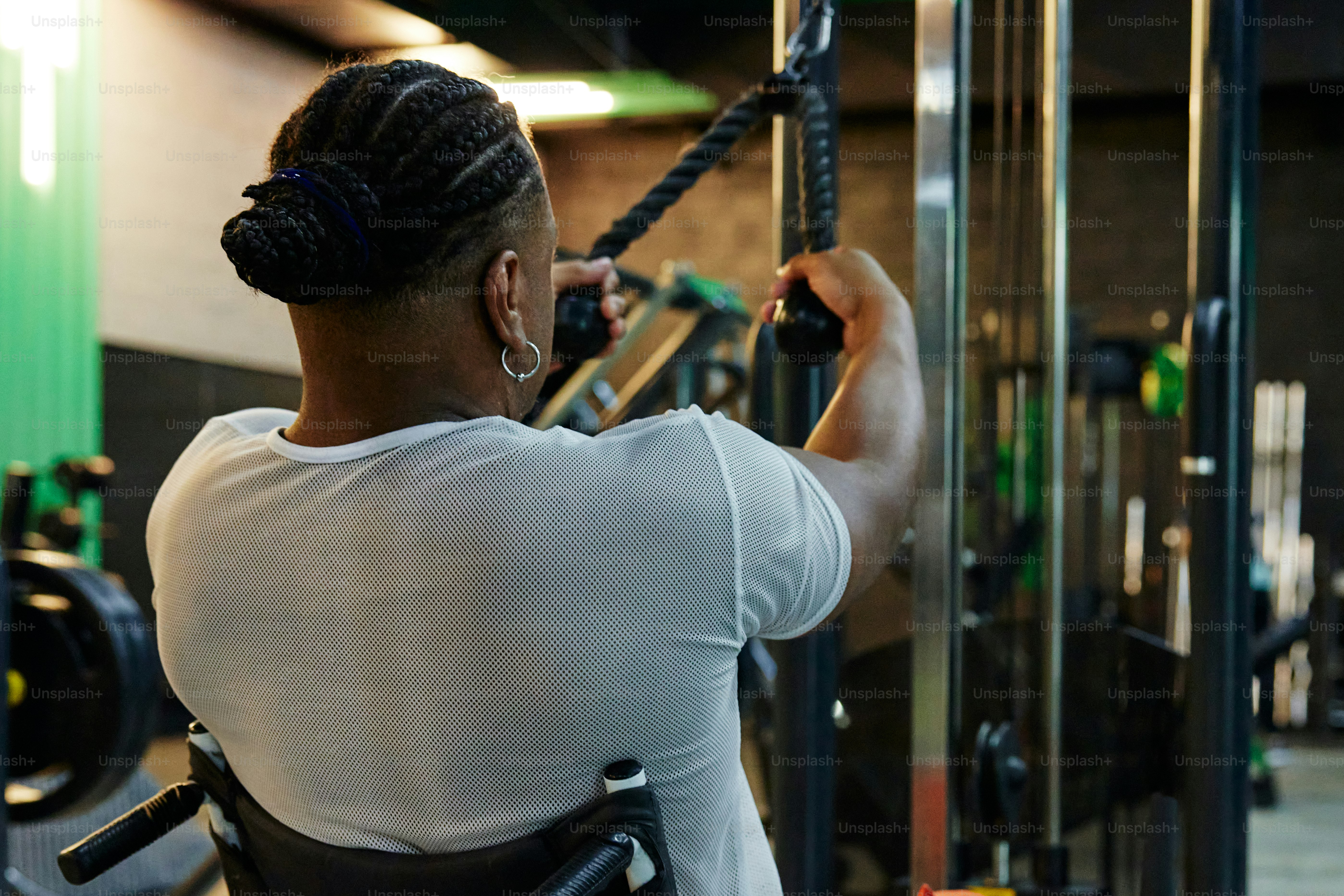 a woman working out in a gym with a pull up bar