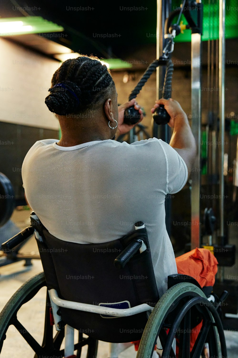 a woman in a wheelchair working on a machine