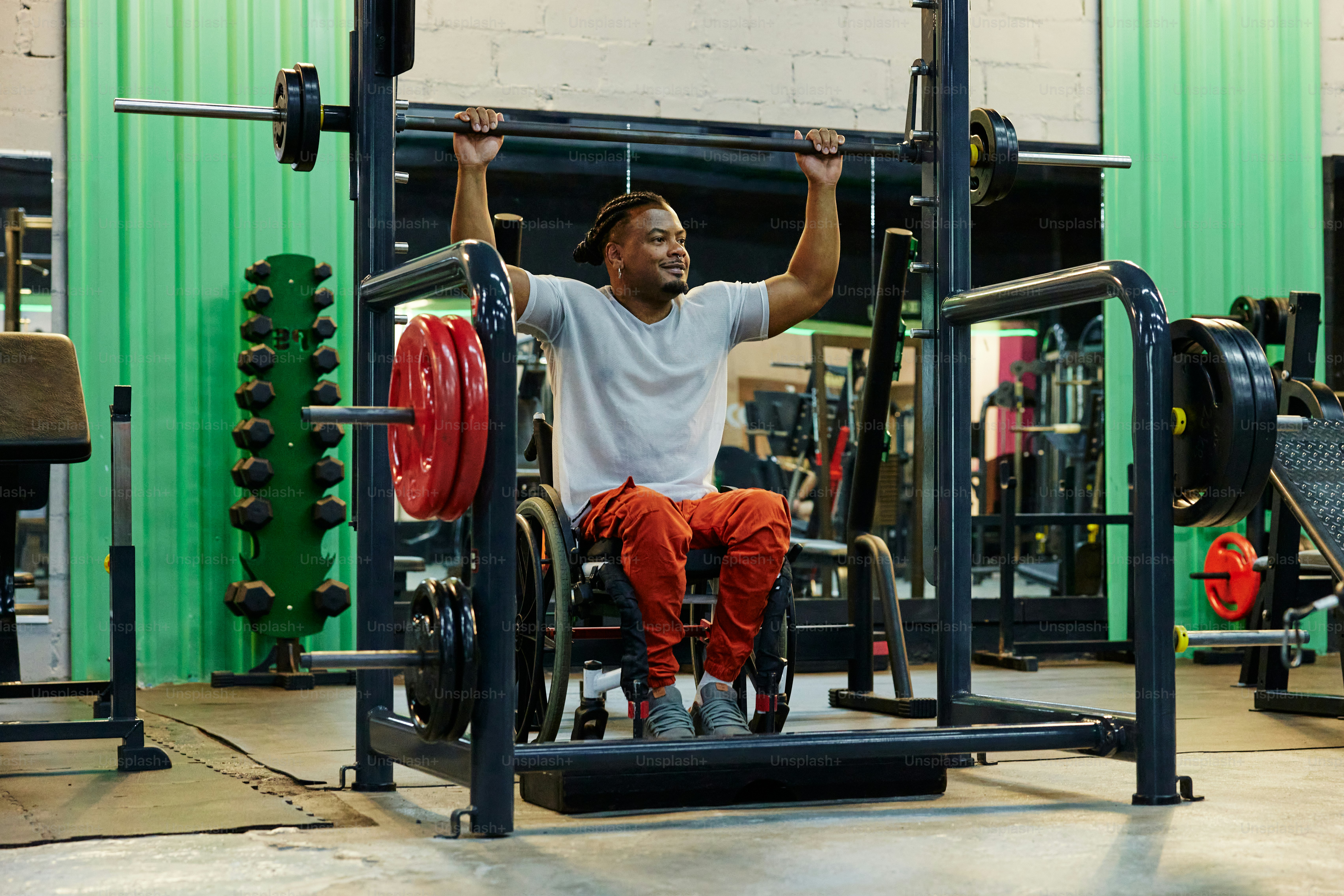 a man sitting on a bench in a gym