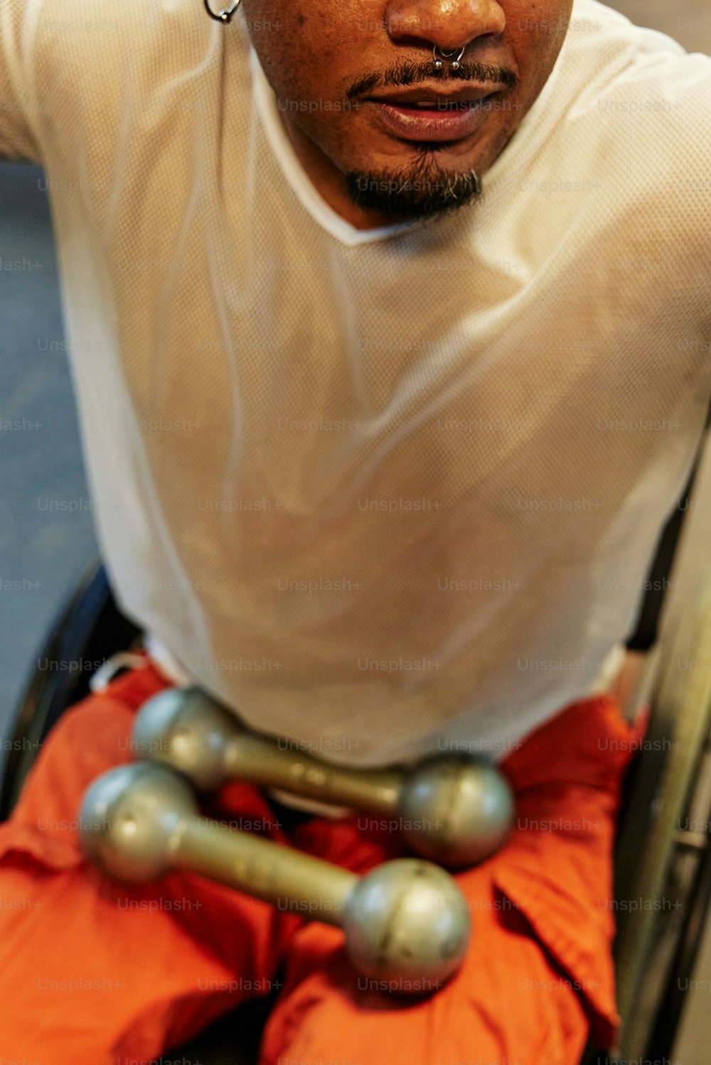 a man sitting in a wheelchair with his hand on his head