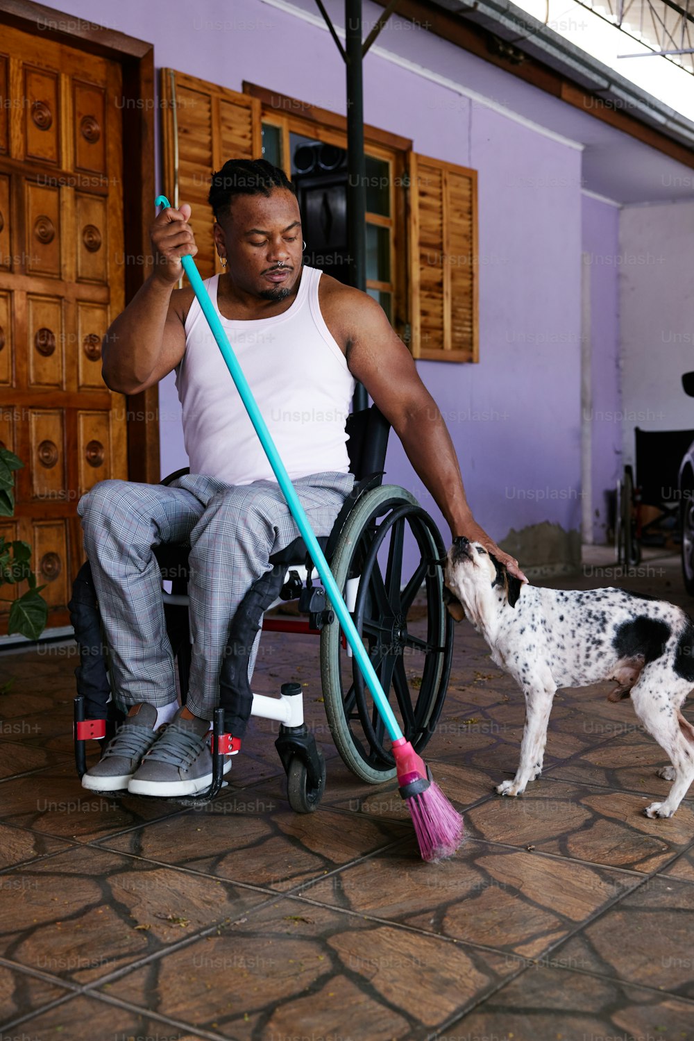 a man in a wheel chair with a dog