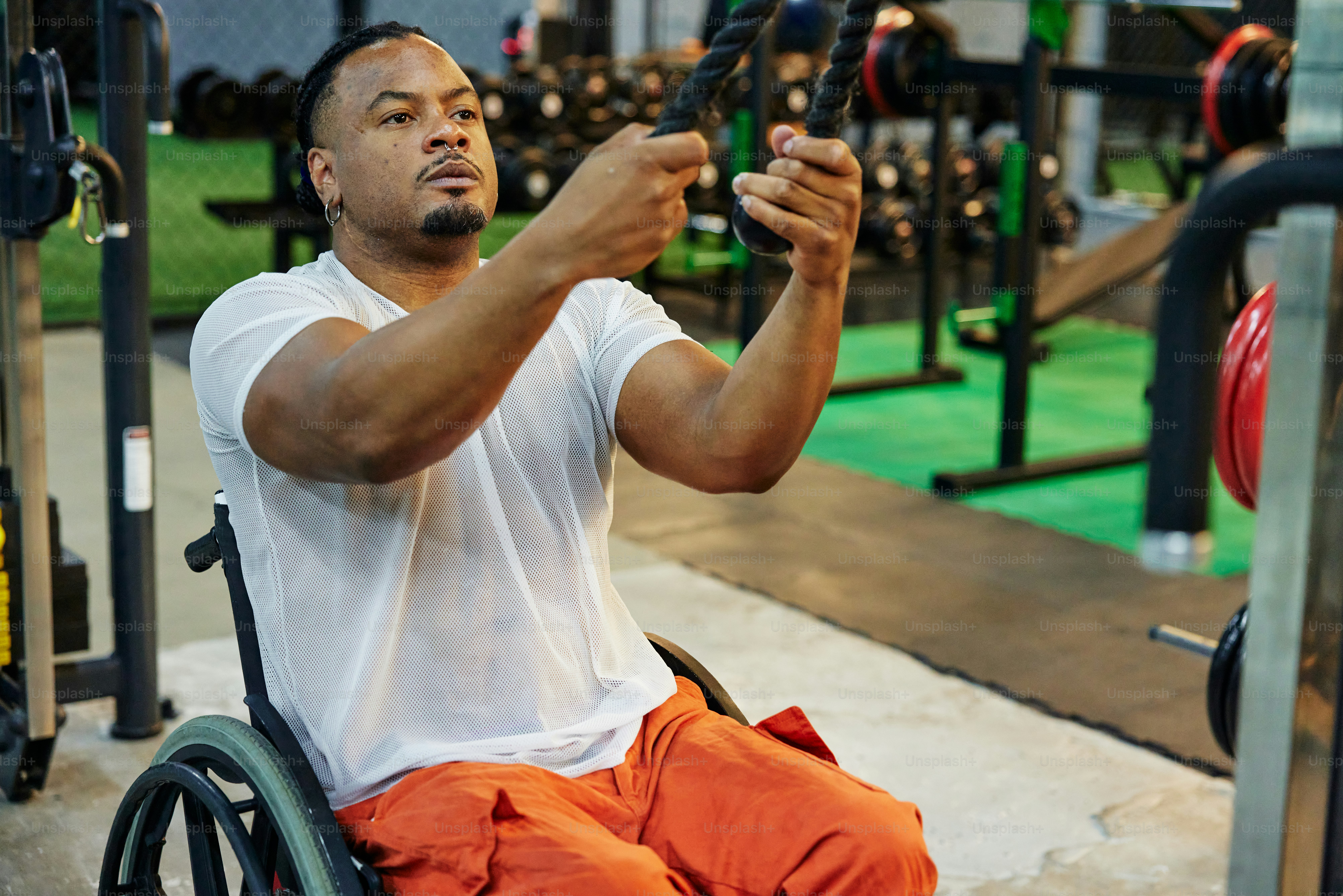 a man in a wheelchair holding a barbell
