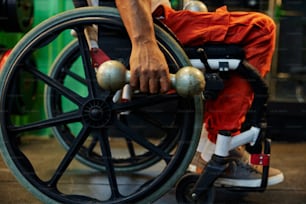 a person in a wheel chair holding two balls