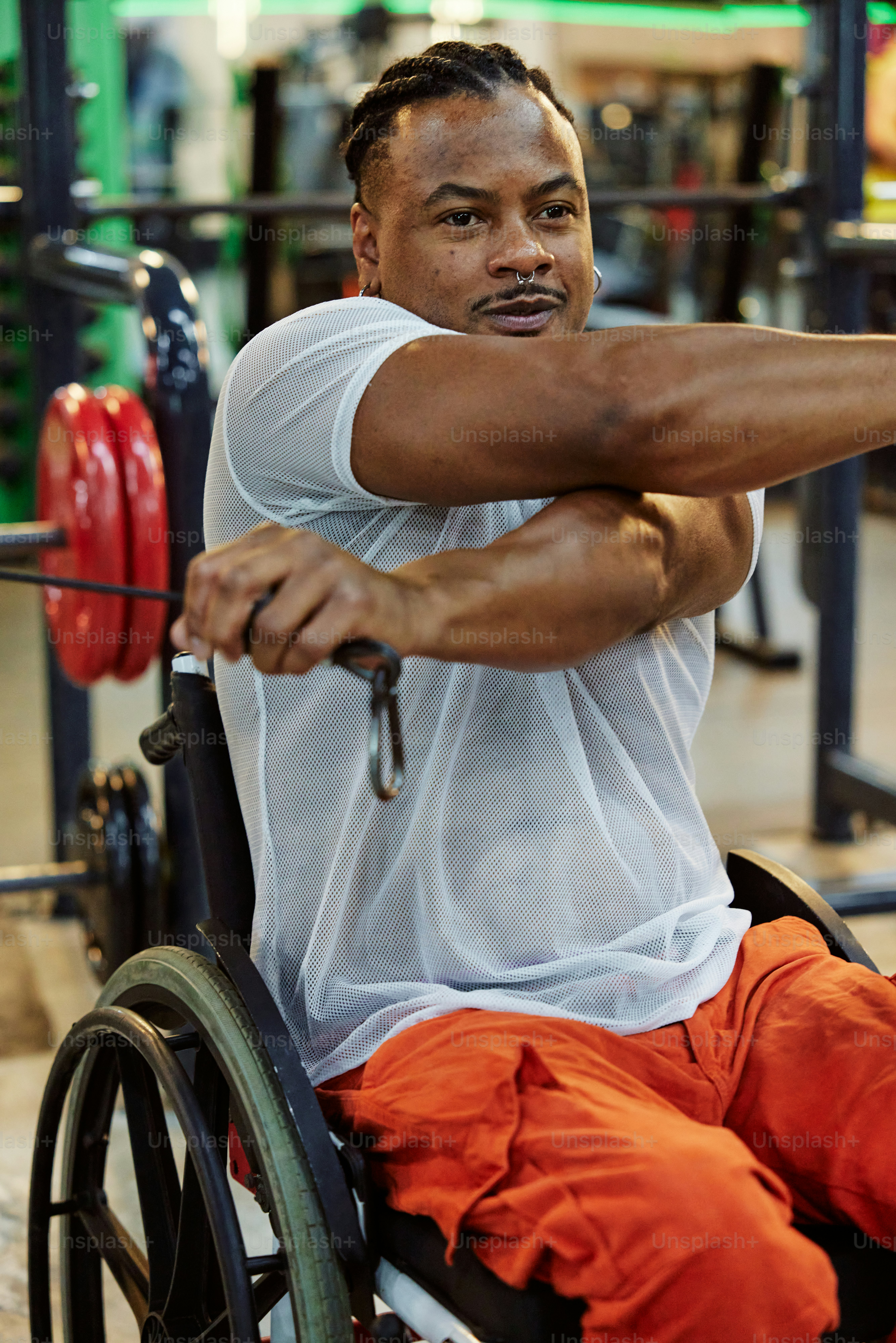 a man in a wheelchair holding a barbell