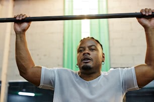 a man lifts a bar in a gym