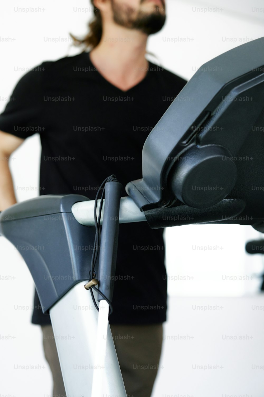 a man standing next to a stationary exercise bike