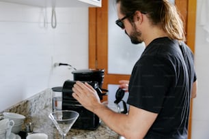 a man standing in a kitchen next to a counter