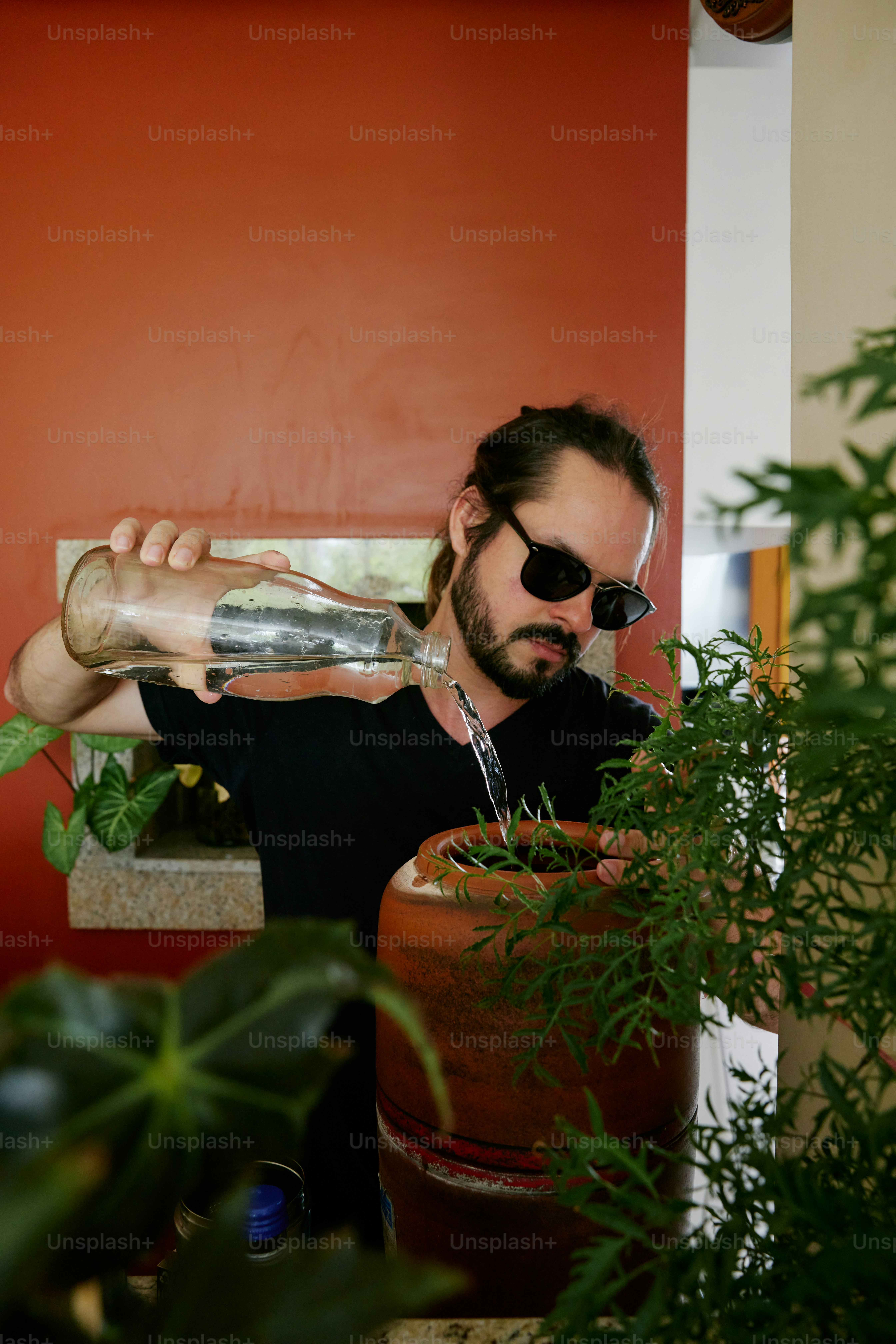 a man drinking water from a water bottle