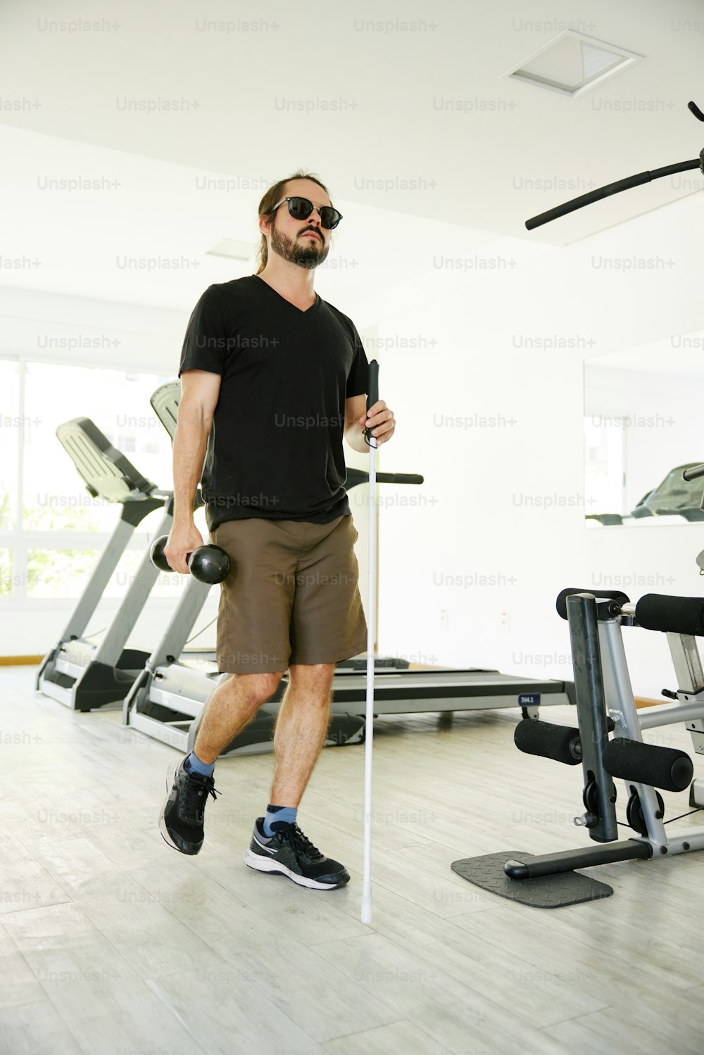 a man standing in front of a gym machine