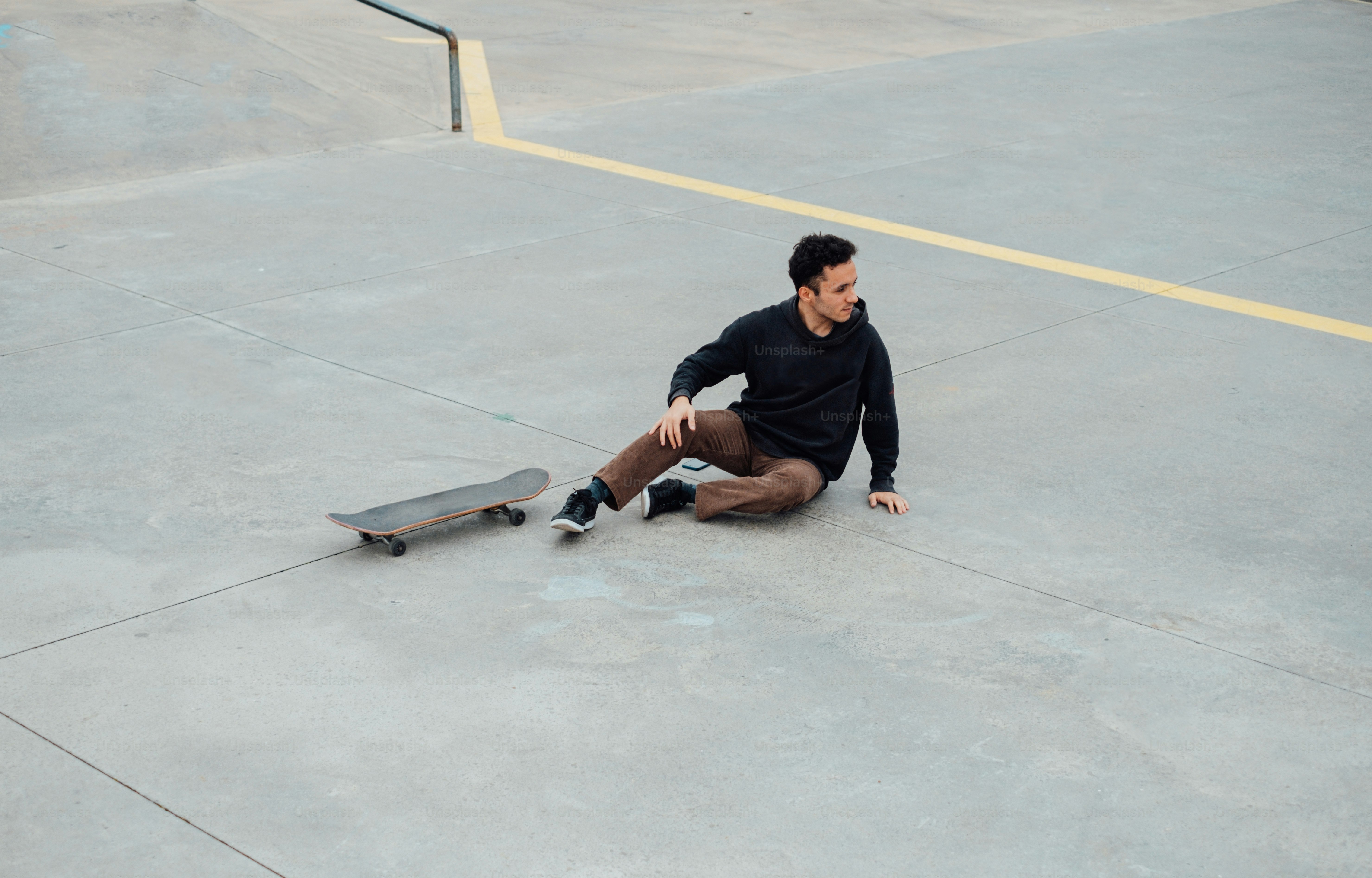 a man sitting on a skateboard