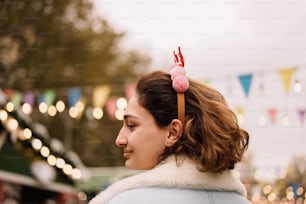 a person with a pink flower in the hair