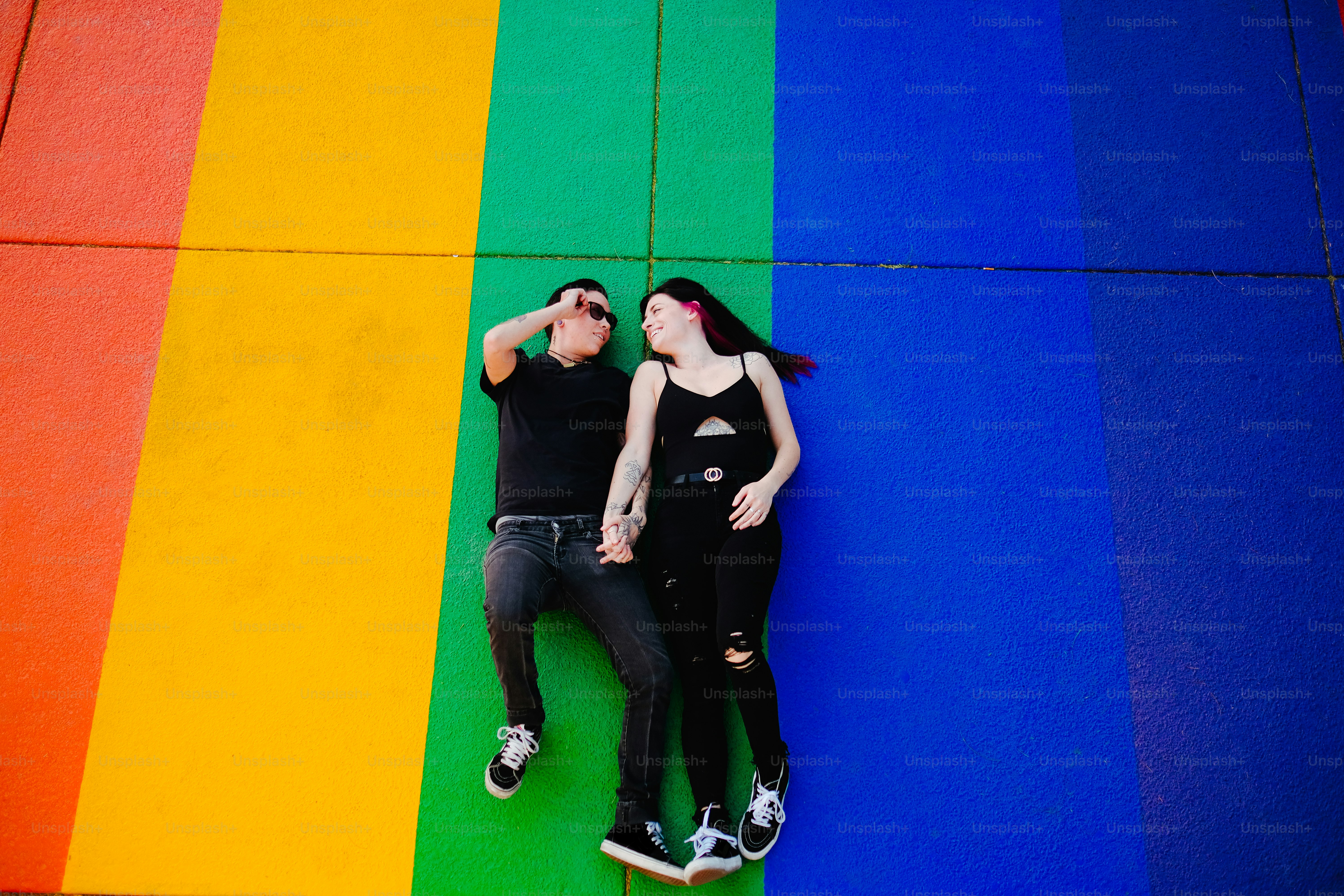 a man and woman posing in front of a flag