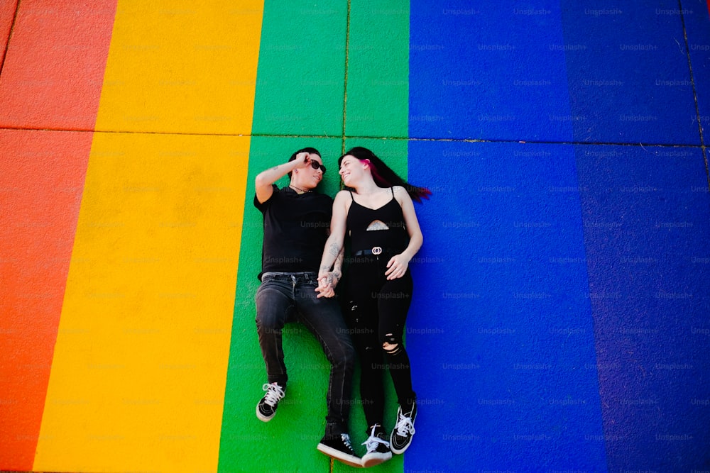 a man and woman posing in front of a flag