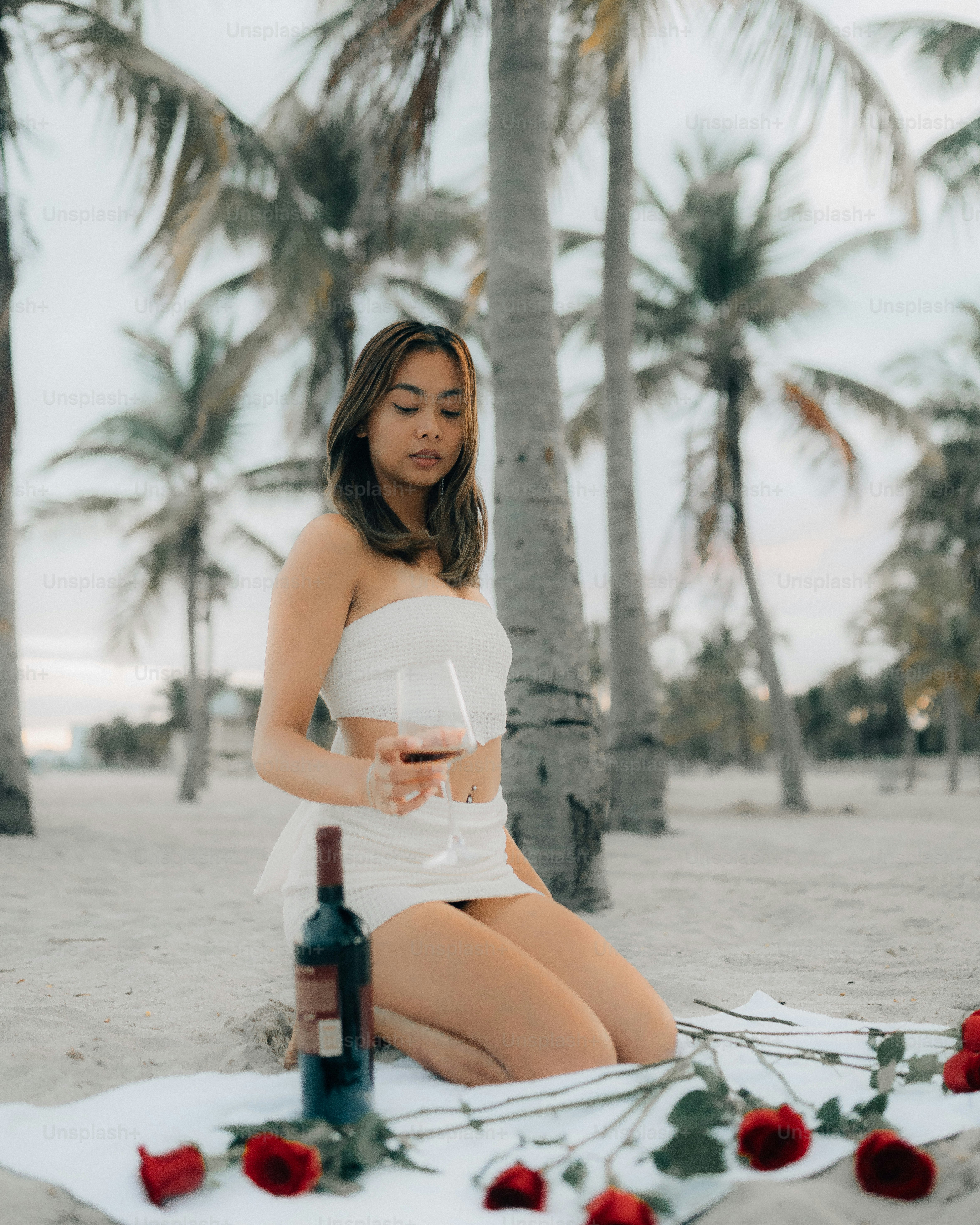 a woman sitting on a beach