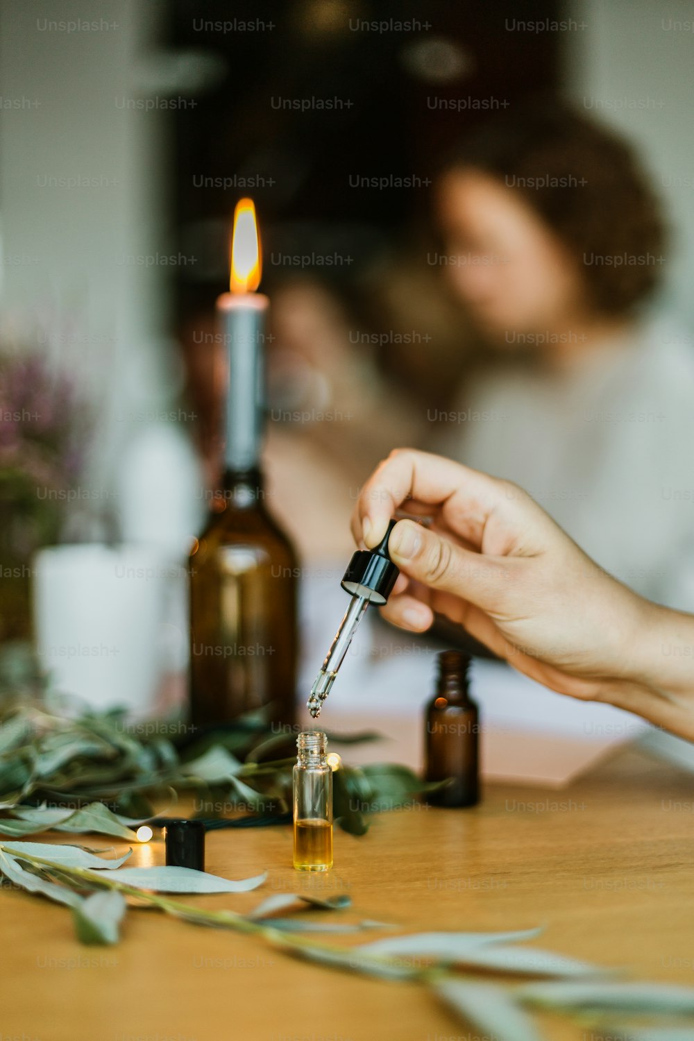 a person lighting a candle on a table