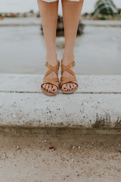 Woman holding a pair of blue sandals during daytime photo – Free Sandal  Image on Unsplash