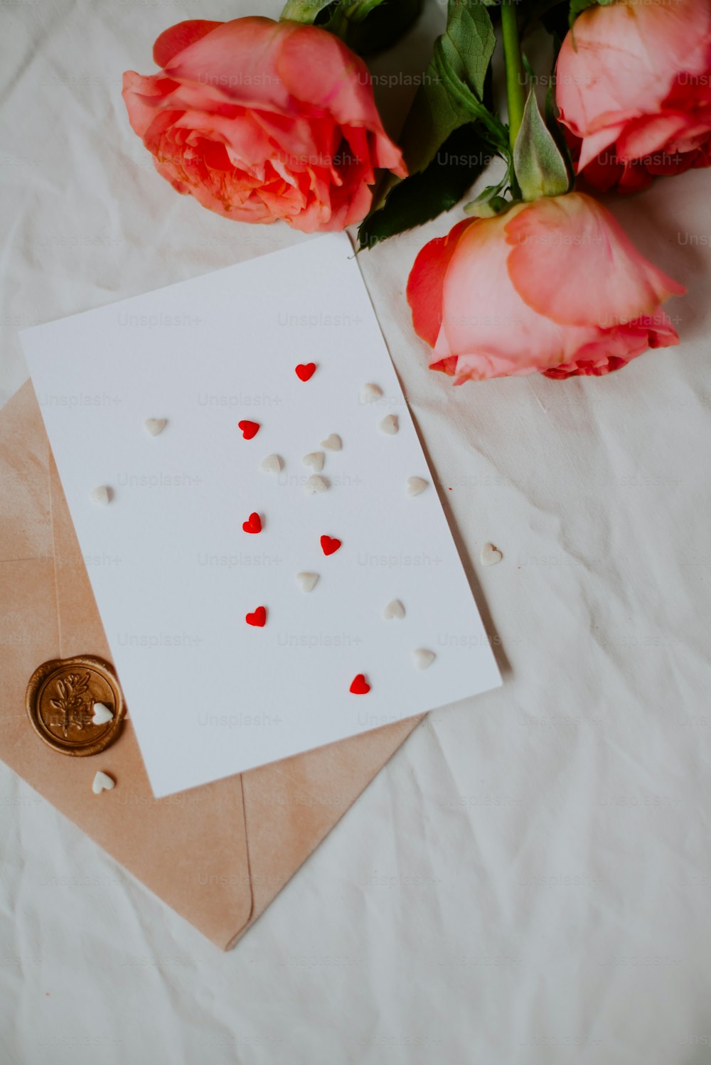 a white napkin with pink roses on it