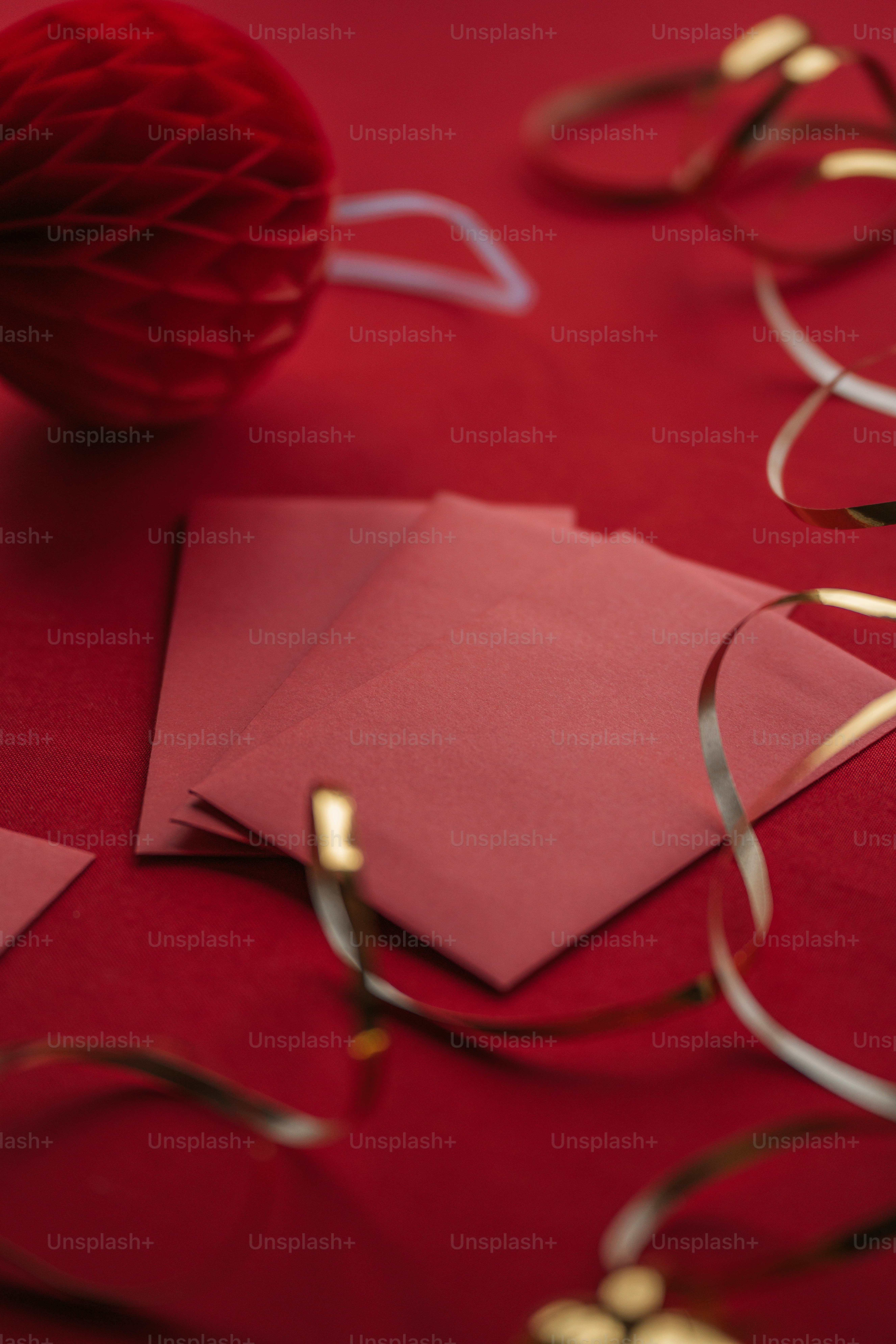 a red table topped with lots of paper and a ball of string