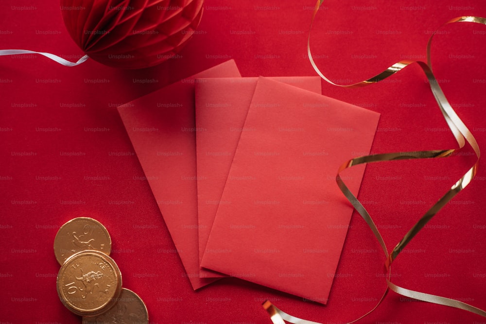 two red envelopes and a gold coin on a red background