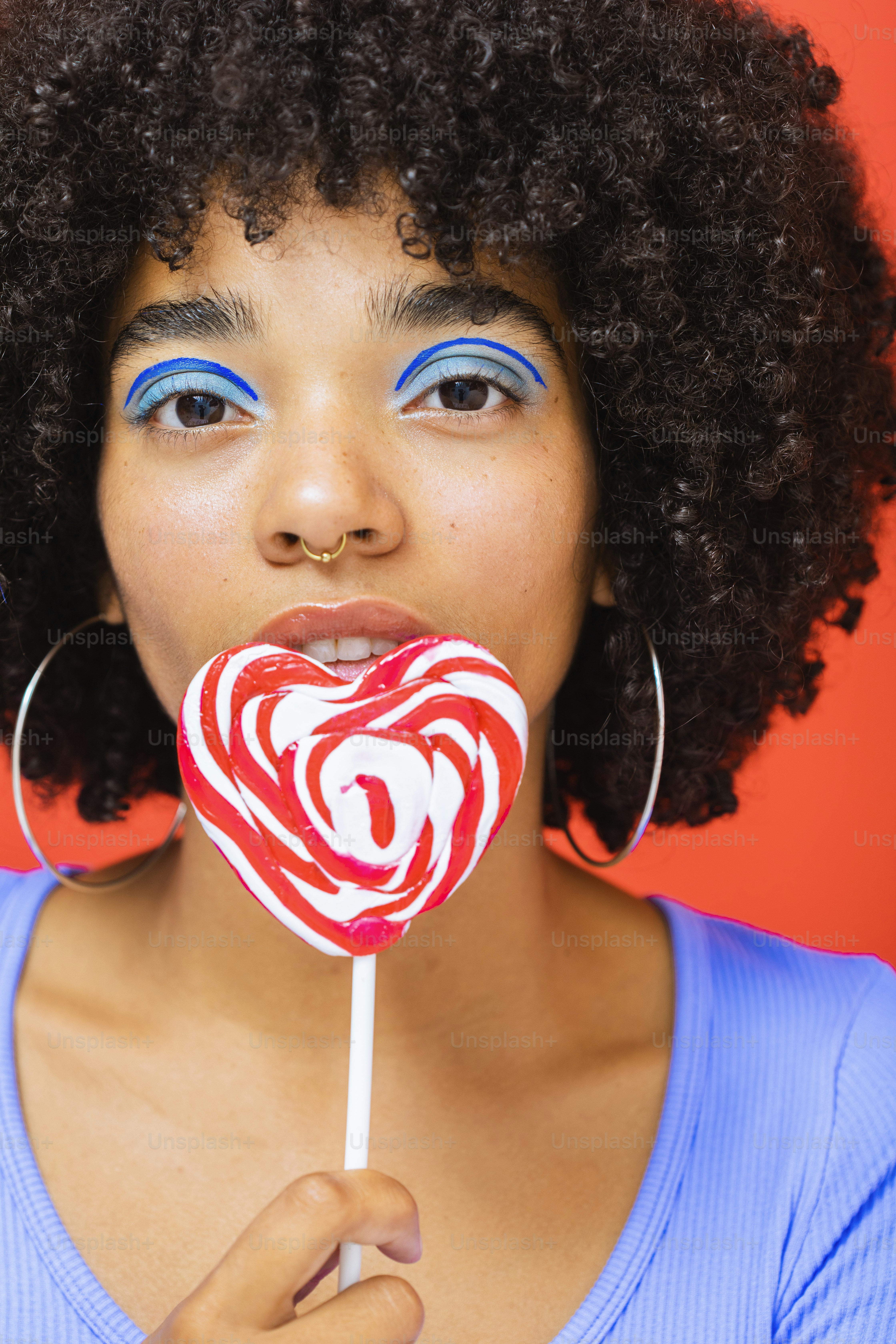 A person drinking from a straw photo Lolipop Image on Unsplash