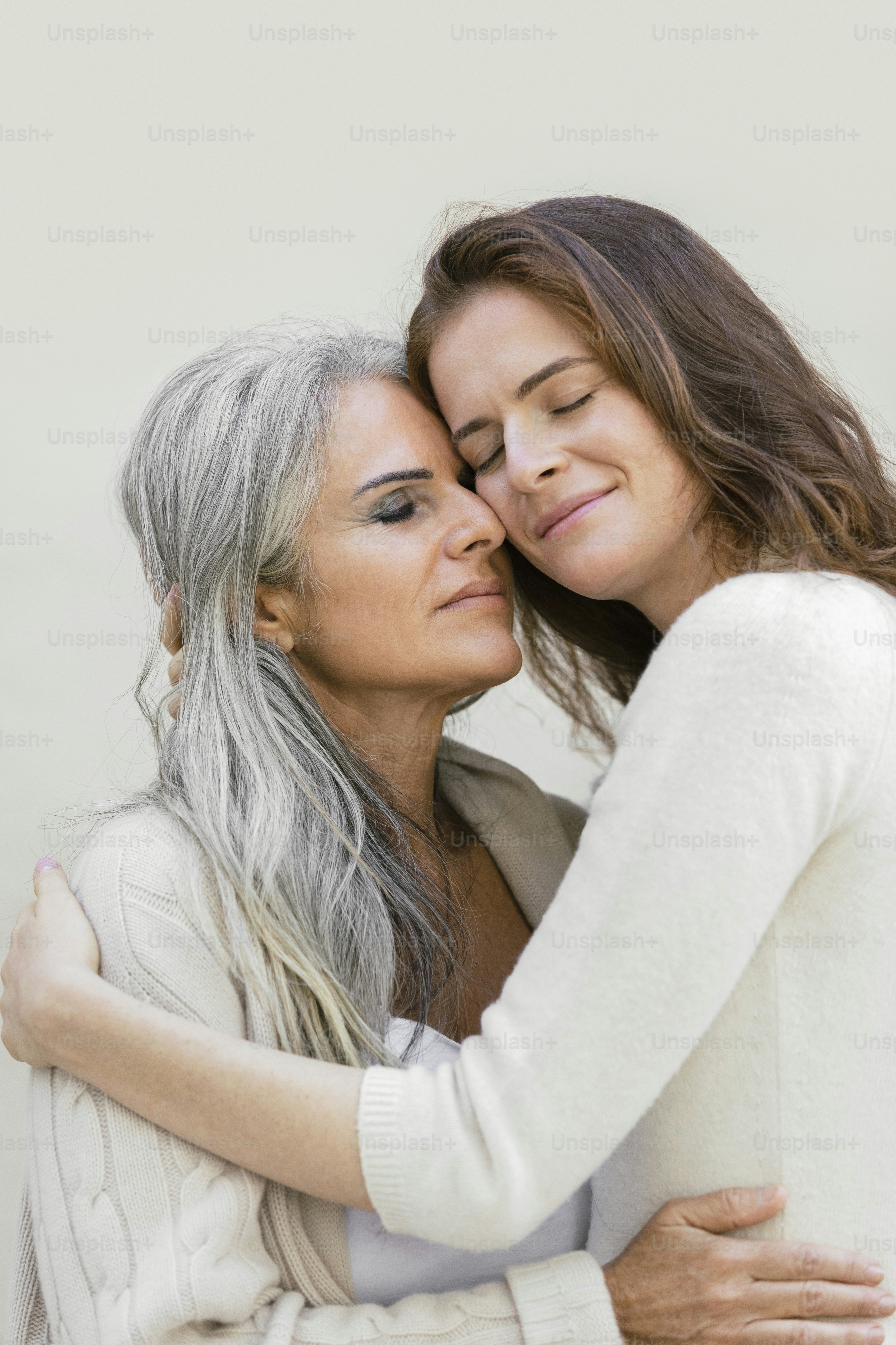 a person kissing another woman on the cheek
