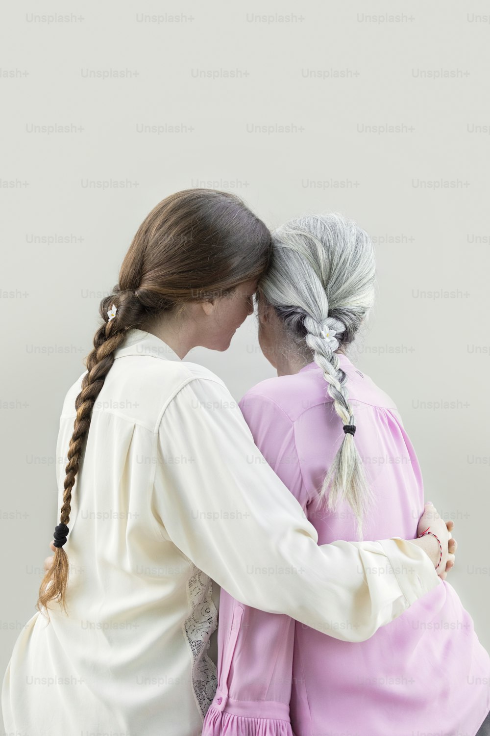 a person kissing another woman