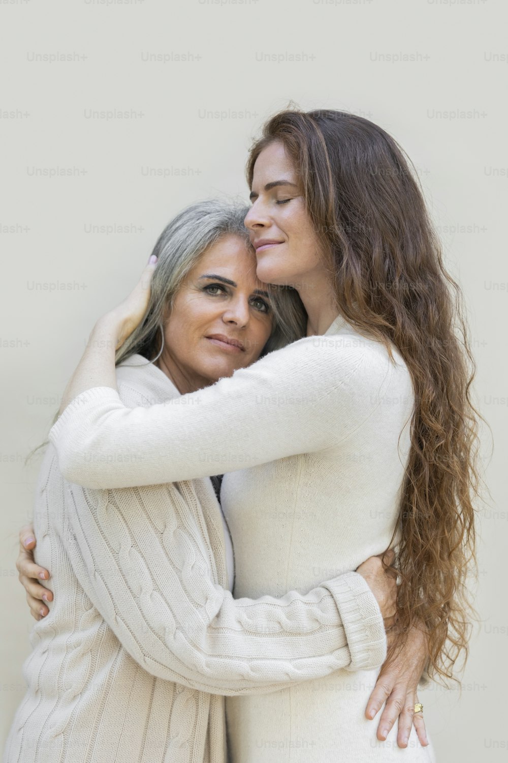 a woman hugging another woman