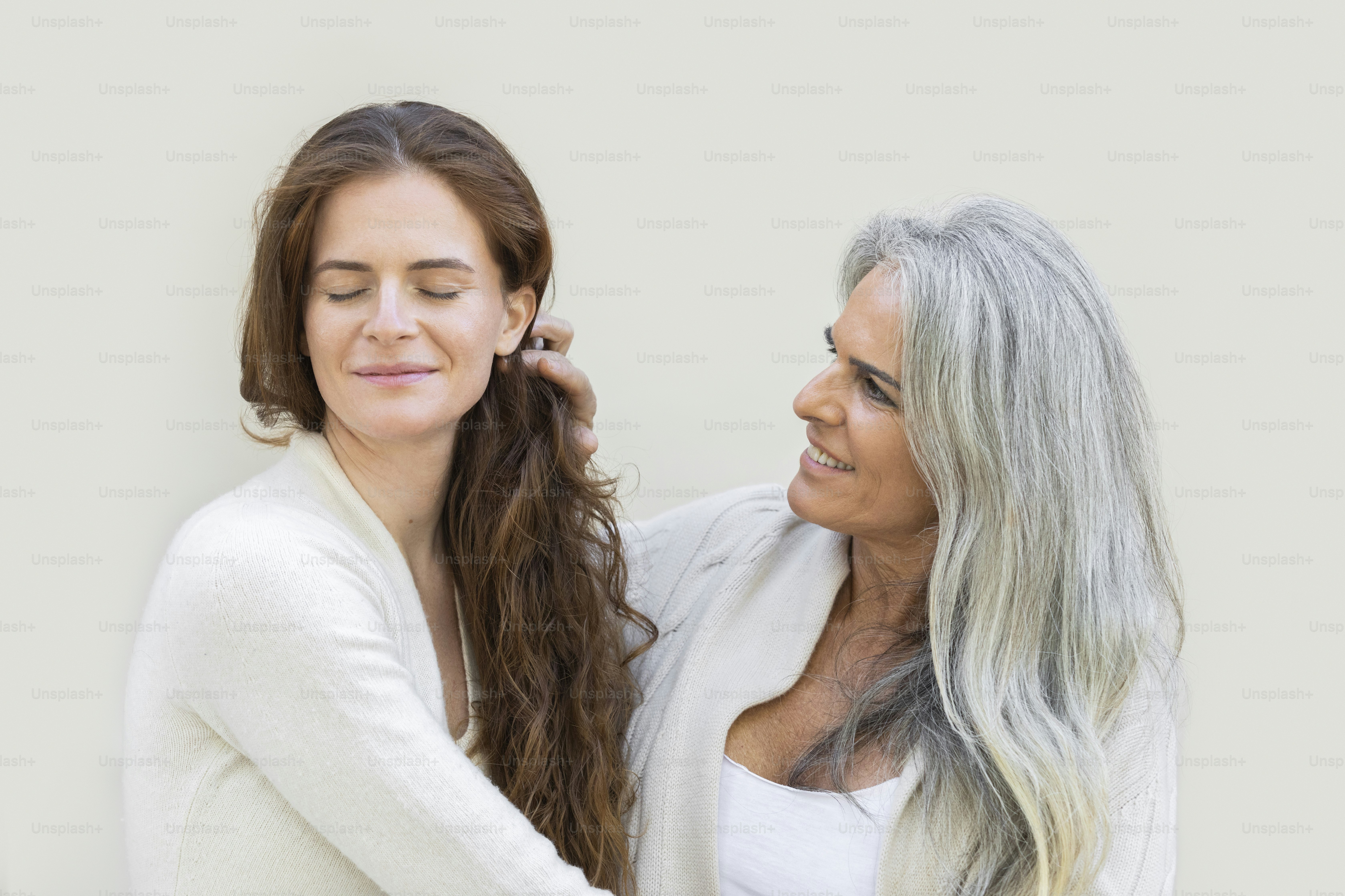 two women standing next to each other smiling