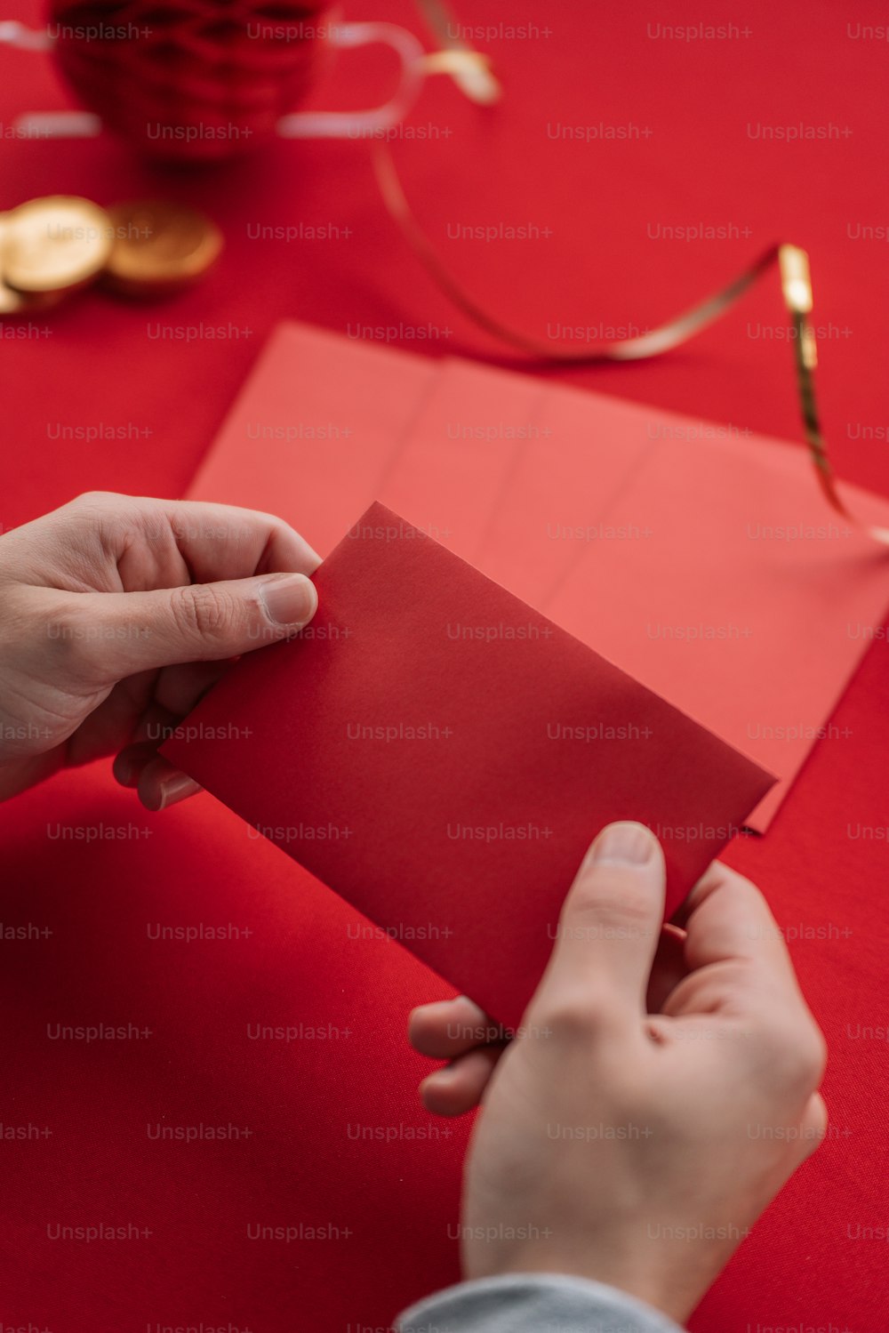 a person holding a piece of red paper