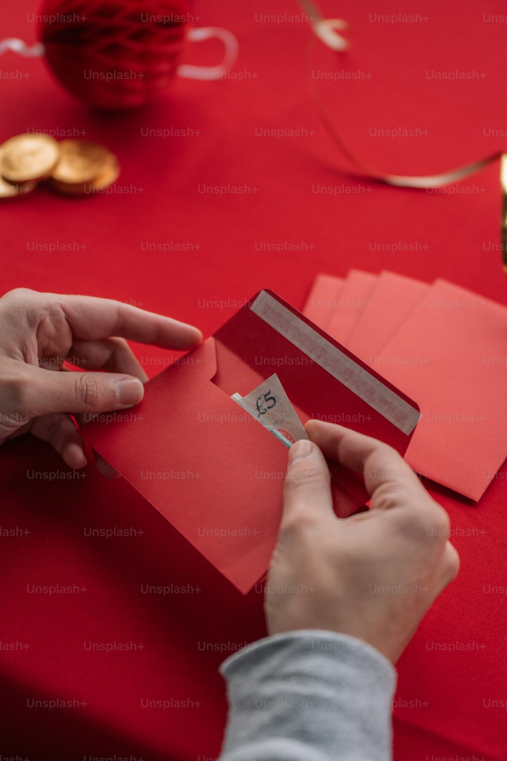a person cutting out a piece of red paper